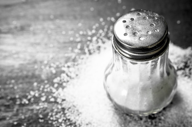 Salt in glass. On the black chalkboard.