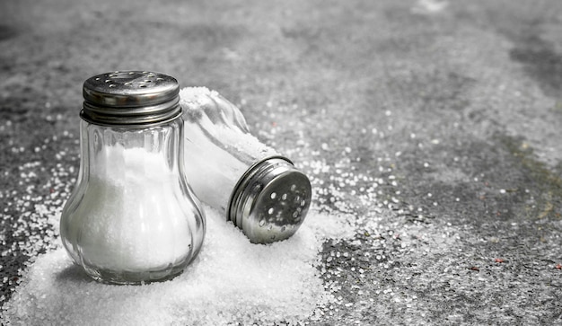 Salt in glass. On rustic table