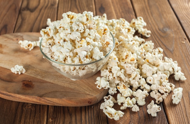 Salt popcorn on the wooden table