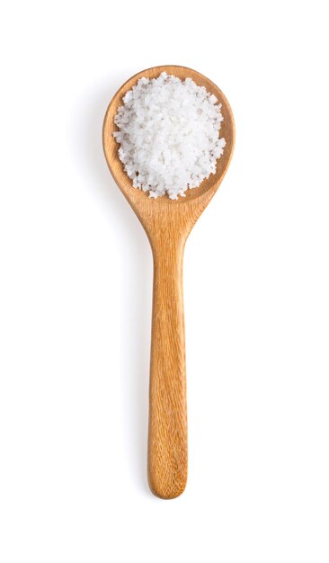 Salt in woodn spoon isolated on white background top view