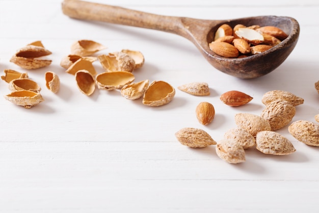 Salted almonds in shell on wooden table