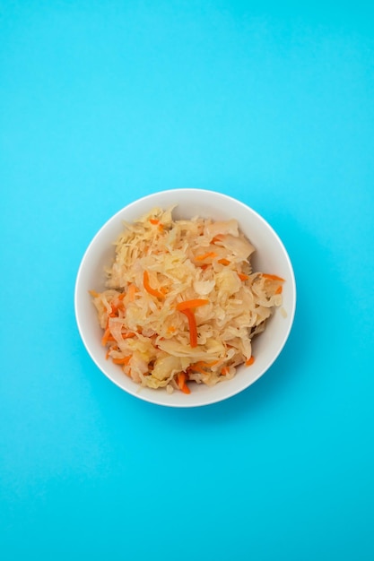 Salted cabbage with carrot in white bowl