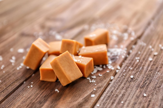 Salted caramel candies on wooden table