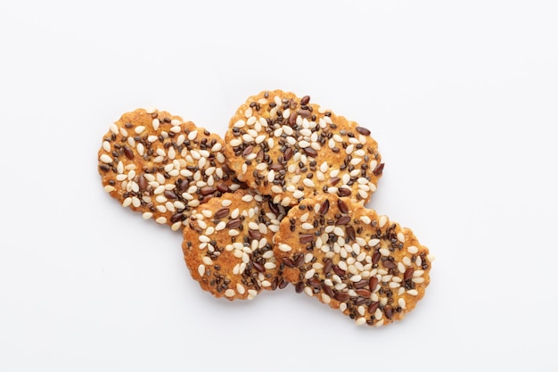 Salted crispy crackers with sesame, sunflower seeds isolated on white background.