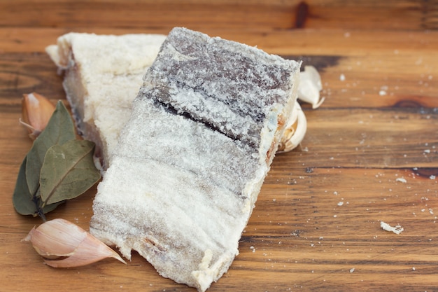 Salted dry codfish on wooden surface