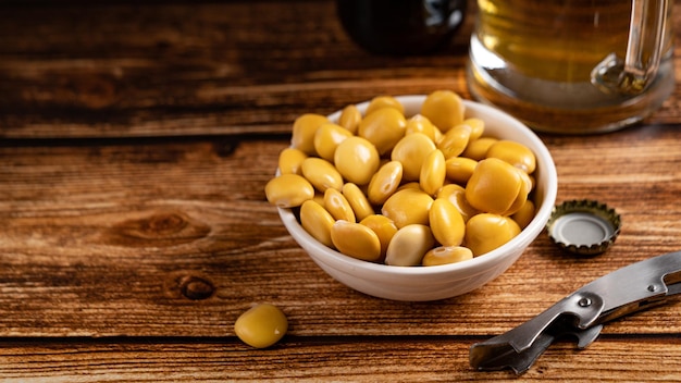 Salted Lupin Beans with beer on table with copy space