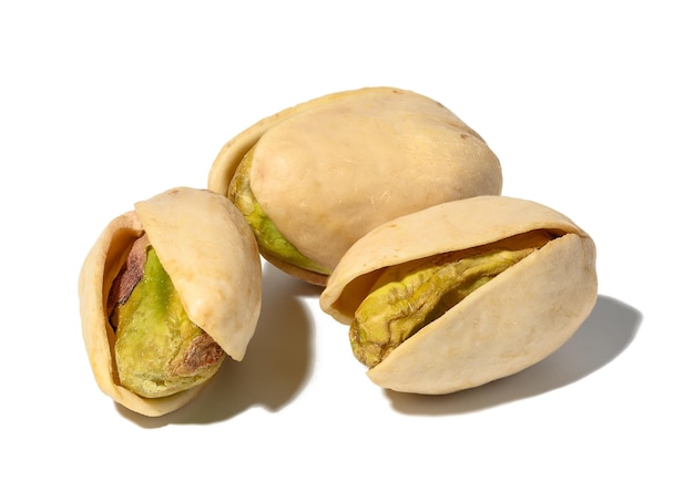 Salted open inshell pistachios isolated on a white background tasty and healthy snack close up