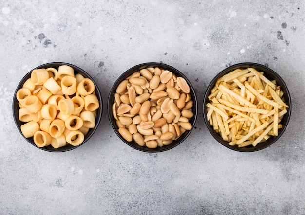 Salted potato fries and rings and peanuts