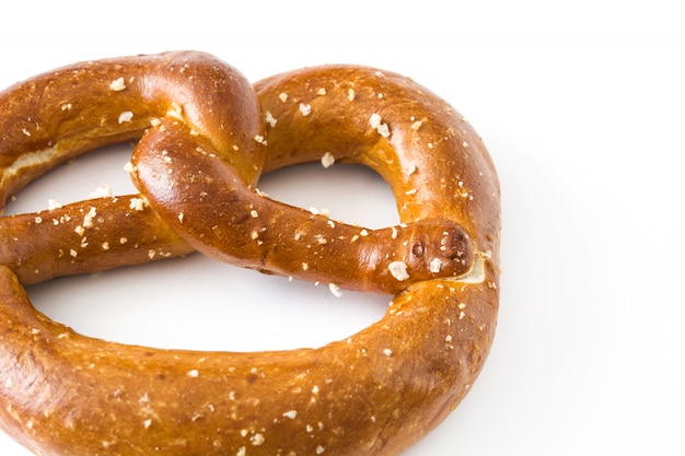 Salted pretzel isolated on white surface