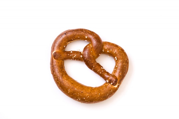 Salted pretzel isolated on white surface