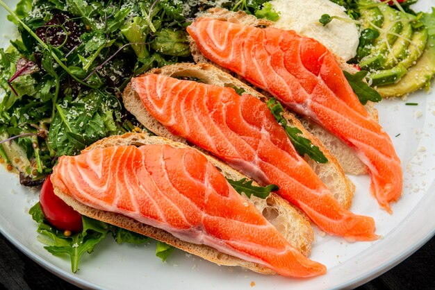 Salted salmon on croutons with fresh salad and cream cheese