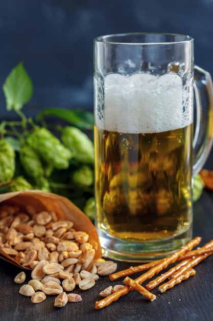 Salted sticks peanuts and mug of beer