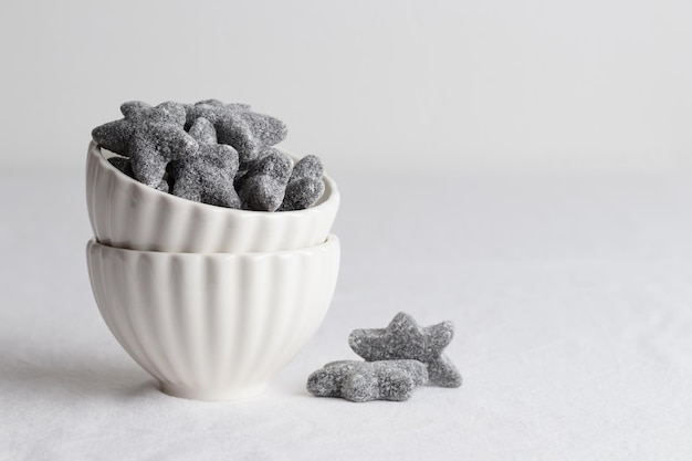 Salty liquorice salmiakki in Finnish in a white bowl