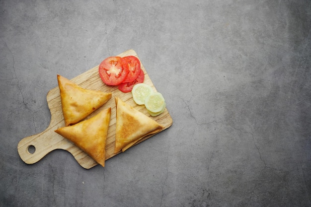 Samosa an Indian popular street food on a chopping board on table