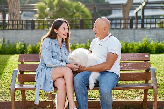 Samoyed dog with her female owner at the park playing together