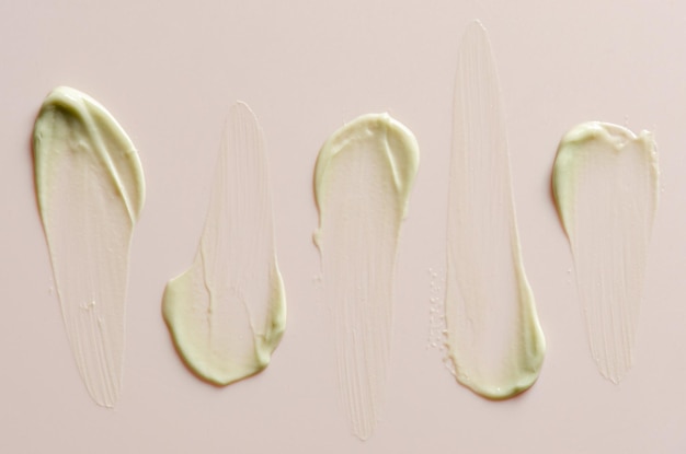 A sample of moisturizer on a pink background Cosmetic product for the skin