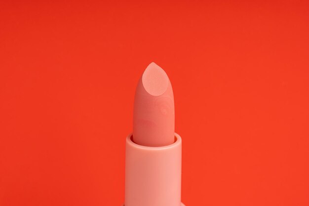 A sample of rose lipstick on a red background