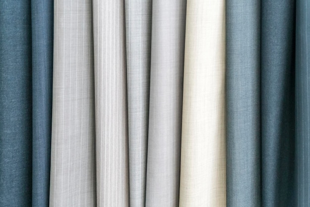 Samples of fabric - trouser fabrics of different colors on the display case