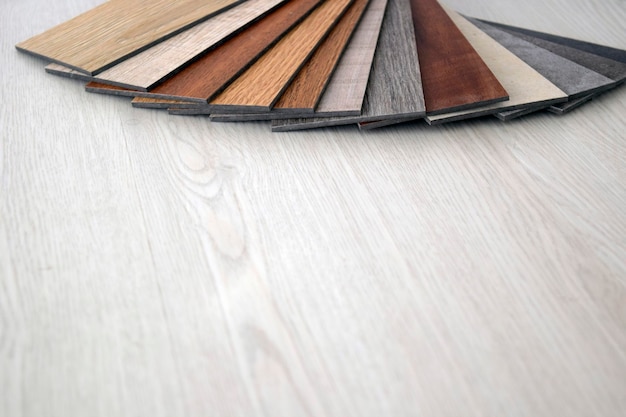 Samples of laminate and vinyl floor tile on wooden BackgroundWood texture floor