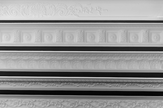 Samples of moldings on the wall in the store Modern trends and materials in interior design Front view Black and white