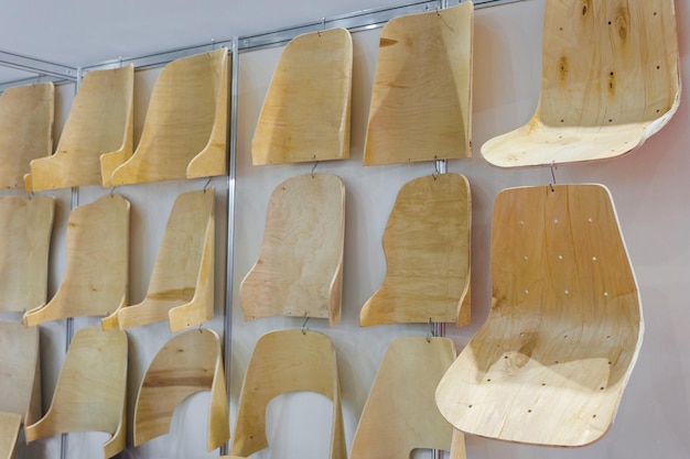 Samples of wooden chairs armchairs at the exhibition Blanks at a furniture factory