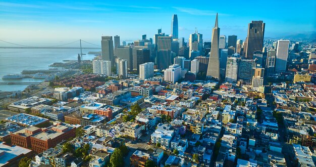 San Francisco golden light on city from aerial above buildings with skyscrapers looming behind CA