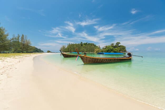 sand beach and Long-tail boat at Kham-Tok Island (koh-kam-tok), The beautiful sea Ranong Province, Thailand.