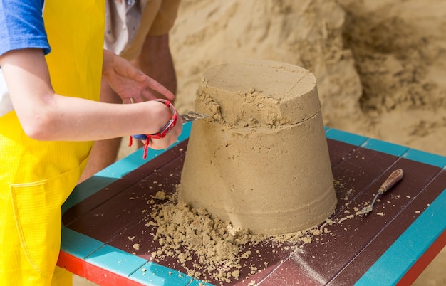 Sand castle made by kids on a craft lesson on beach