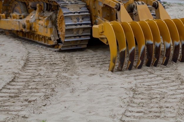 Sand cleaning machine on the beach furrows in the sand