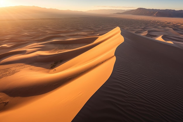 A sand dune in the desert at sunset