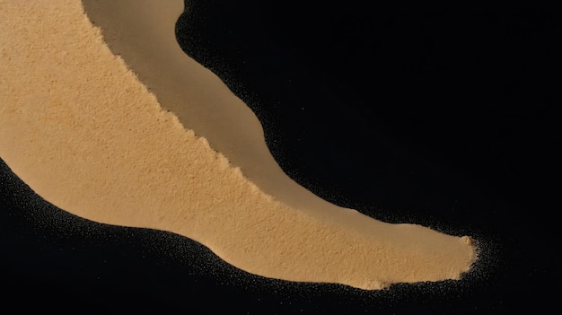 sand scattered isolated on black background and texture copyspace