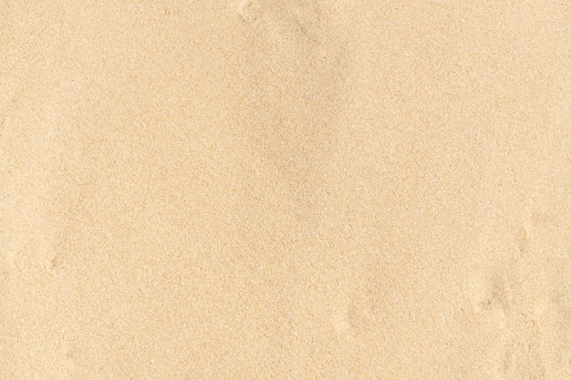 Photo sand texture background. brown desert pattern from tropical beach. close-up.