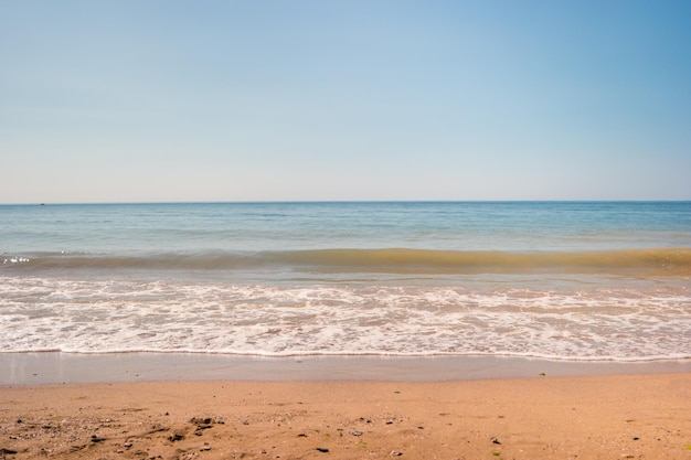 Sand with sea water cloudless sky and horizon perfect spot for summer rest little piece of paradise