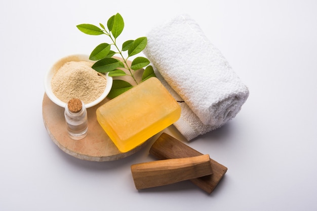 Sandalwood or Chandan Handmade Bath Soap. Placed with Oil, Ubtan, Sticks and Towel, selective focus