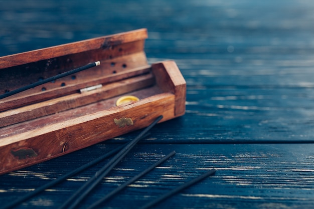 Sandalwood sticks on a black wooden table. Traditional Asian culture. Aromatherapy