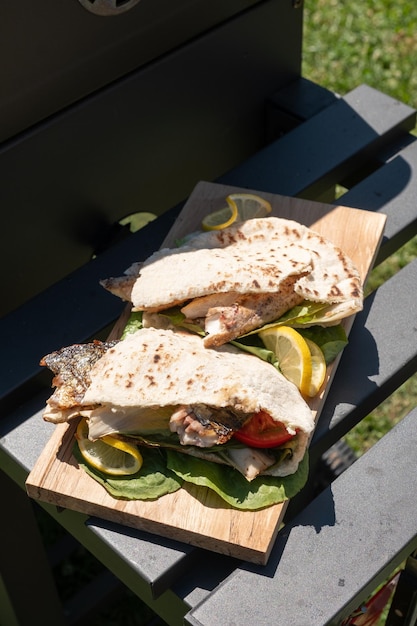 Sandwich balik ekmek with grilled fillet of mackerel tomatoes onions and lettuce