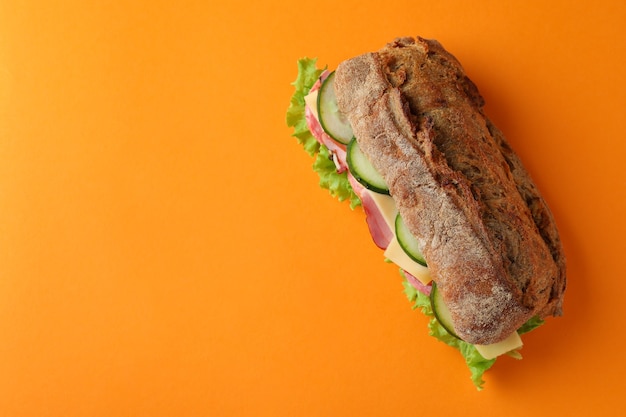 Sandwich of ciabatta bread on orange background