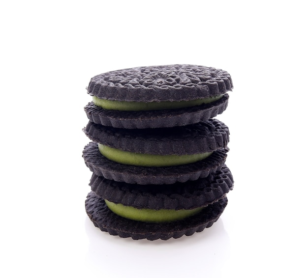 Sandwich cookies with green cream on white background