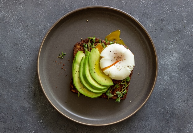 Sandwich with avocado and poached egg. Healthy eating Vegetarian food. Breakfast.