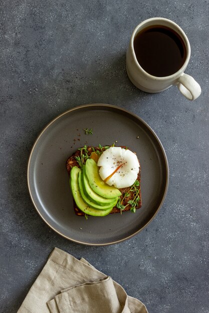 Sandwich with avocado and poached egg. Healthy eating Vegetarian food. Breakfast.