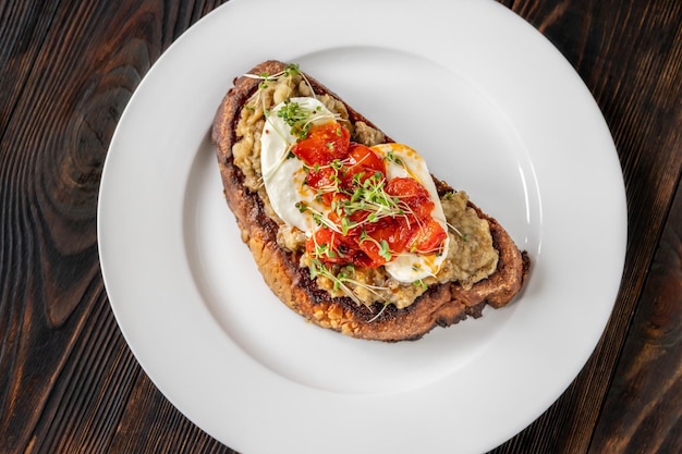 Sandwich with baked eggplant, tomatoes and mozzarella