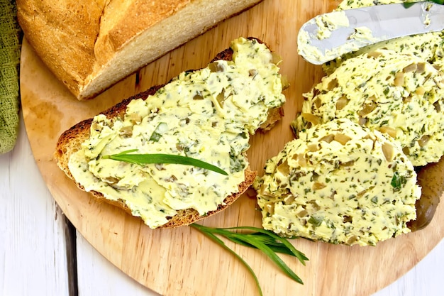 Sandwich with butter spinach and cucumbers on board top