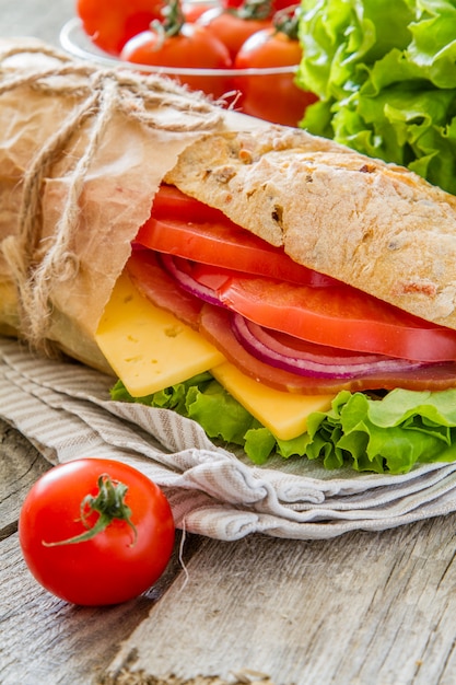 Sandwich with cheese abd ham, salad and tomatoes