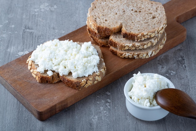 Sandwich with cottage cheese on a wooden table