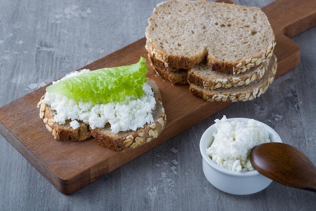 Sandwich with cottage cheese on a wooden table