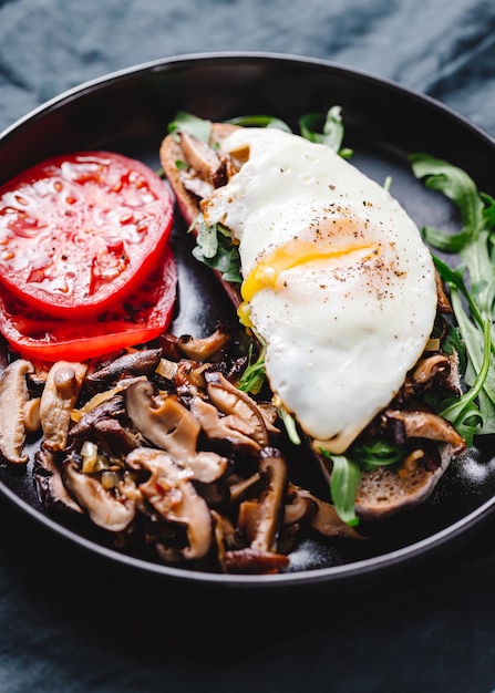 Sandwich with fresh arugula fried shiitake mushroom shallot onion egg served with tomatoes