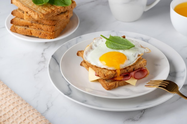 Sandwich with a fried egg bacon cheese and spinach