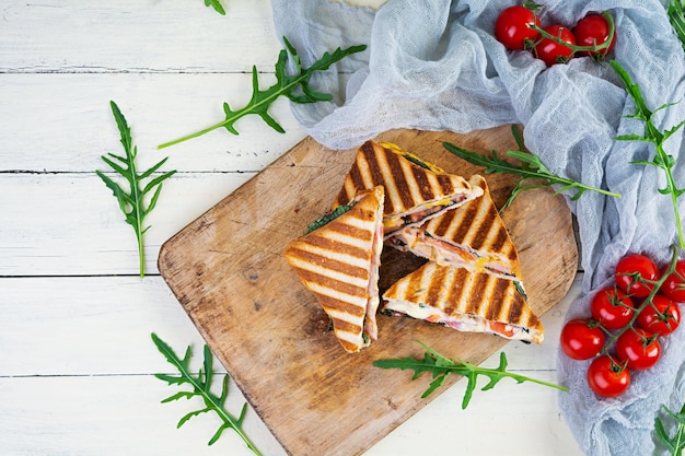 Sandwich with ham cheese mustard leaves tomatoes and onion Tasty grilled sandwiches