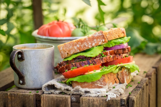 Sandwich with lettuce tomato and ham in greenhouse