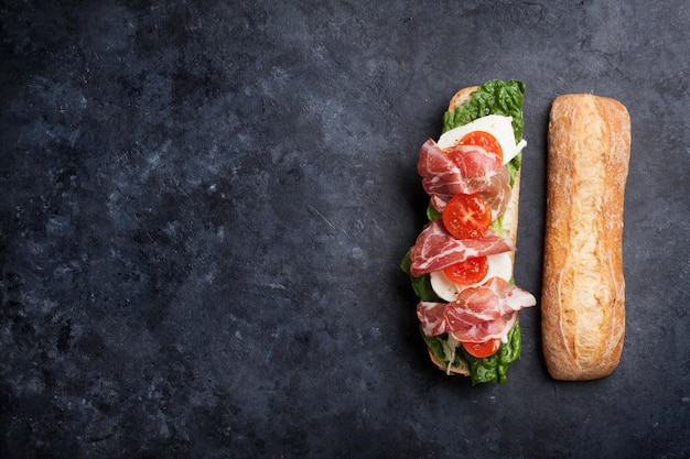 Sandwich with salad prosciutto and mozzarella